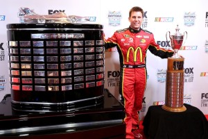 DAYTONA BEACH, FL - FEBRUARY 12: NASCAR Sprint Cup Series driver Jamie McMurray poses with the Daytona 500 and Rolex 24 trophies during the 2015 NASCAR Media Day at Daytona International Speedway on February 12, 2015 in Daytona Beach, Florida.  (Photo by Jerry Markland/Getty Images)