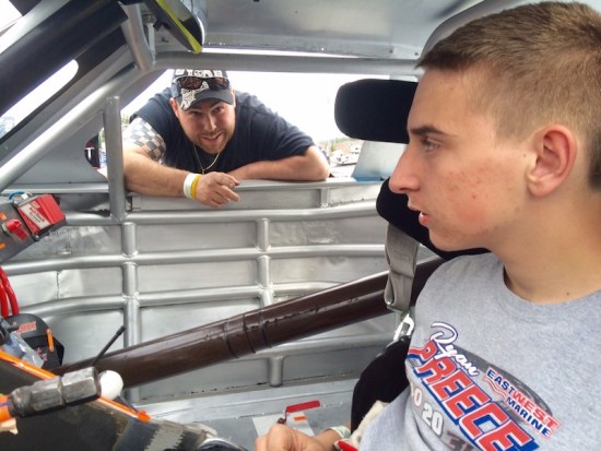 Johnny Walker leans in the car to offer some tips to DARE Stock division rookie Zack Robinson at Stafford Motor Speedway 