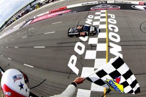 Martin Truex Jr. crosses the finish line to win Sunday's Sprint Cup Series event at Pocono Raceway (Photo: Brian Lawdermilk/Getty Images for NASCAR)