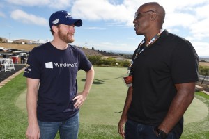 Dale Earnhardt Jr. (left), sporting a Microsoft shirt while talking with former Major League Baseball player Barry Bonds before to the Sprint Cup Series Toyota/Save Mart 350 at Sonoma Raceway Sunday (Photo: Rainier Ehrhardt/Getty Images for NASCAR)