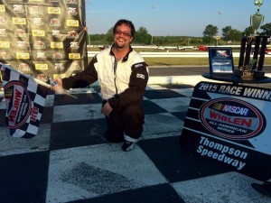 Jesse Gleason celebrates in victory lane at Thompson Speedway without his car after running out of fuel following his Limited Sportsman division win 