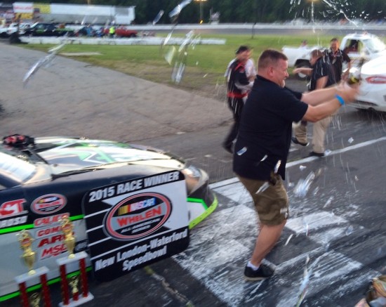 Team owner Scott Fearn celebrates Keith Rocco's 200th career victory with a bottle of champagne in victory lane Saturday at the New London-Waterford Speedbowl 