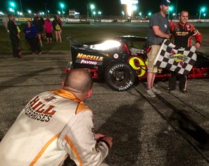 A dejected Woody Pitkat looks on as Anthony Nocella celebrates victory in the Valenti Modified Racing Series event Saturday at Beech Ridge Motor Speedway 