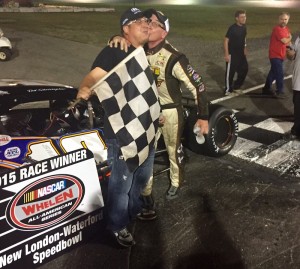 Ted Christopher (right) celebrates victory in the SK Modified feature Saturday at the New London-Waterford Speedbowl with a smooch for track general manager Shawn Monahan (Photo: Mike Serluca/New London-Waterford Speedbowl)