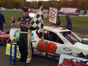 Ron Silk celebrates victory in the second of two Tri-Track Open Modified Series qualifying heats Sunday at the Bemers Super Bowl of Racing at the New London-Waterford Speedbowl 