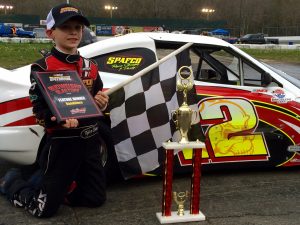 Tyler Barry celebrates victory in the Bandolero feature Saturday at the New London-Waterford Speedbowl 