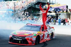 Kyle Busch celebrates after winning the Sprint Cup Series Crown Royal Presents the Combat Wounded Coalition 400 at Indianapolis Motor Speedway Sunday (Photo: Robert Laberge/Getty Images for NASCAR)